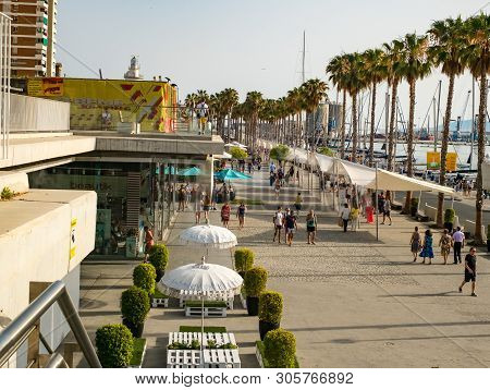 Malaga, Spain - June 23, 2018. People Are Walking Along The Embankment (paseo Del Muelle Dos Promena