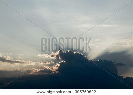 Orange Light With Sun Rays And Dark Clouds On Sky Before Sunset In The Evening. Beautiful Dramatic S