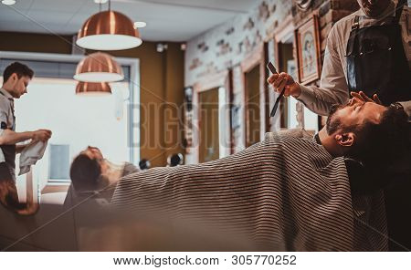 Attractive Relaxed Man Just Got Great Service From Talanted Trendy Barber.
