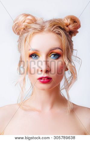 Young Blonde Girl With An Original Hairstyle And Bright Professional Makeup