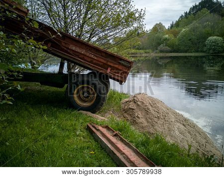 Tractor Trailer Tipping A Load Of Sand To Create Beach
