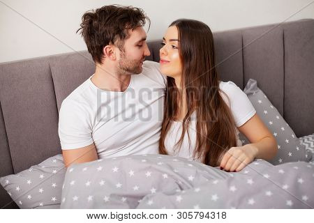 Happy Couple Having Fun In Bed. Intimate Sensual Young Couple In Bedroom Enjoying Each Other