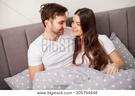 Happy Couple Having Fun In Bed. Intimate Sensual Young Couple In Bedroom Enjoying Each Other