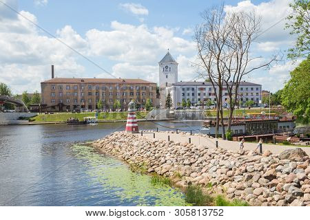 City Jelgava, Latvian Republic. River Lielupe, Peoples And Urban City View. Houses And Walking Paths