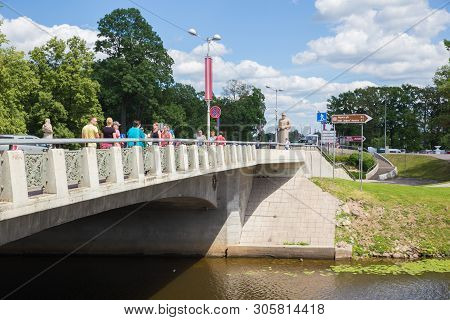 City Jelgava, Latvian Republic. Bridge Over River Lielupe, Peoples And Urban City View. Houses And W