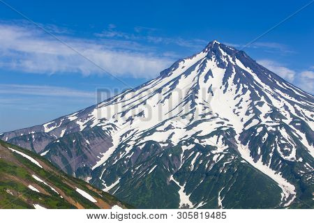 Volcano Viluchinsky Covered With Snow At Sunny Summer Day, The Kamchatka Peninsula.