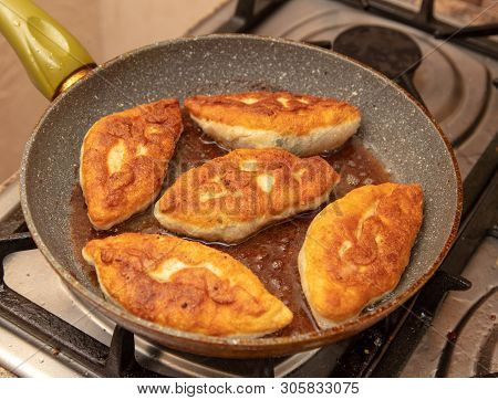 Patties Are Fried In Oil In A Pan .