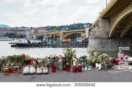 Budapest, Hungary - June 09 2019: Tributes Including Flowers, Candles And Pairs Of Shoes Placed By T
