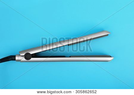 Modern Hair Iron For Straightening On Color Background, Top View