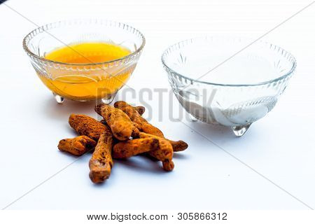Turmeric & Raw Milk Face Pack Isolated On White In A Glass Bowl Along With Some Raw Milk And Turmeri