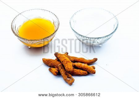 Turmeric & Raw Milk Face Pack Isolated On White In A Glass Bowl Along With Some Raw Milk And Turmeri