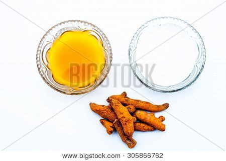 Turmeric & Raw Milk Face Pack Isolated On White In A Glass Bowl Along With Some Raw Milk And Turmeri