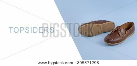 Brown Mens Topsiders Shoes On Blue Background With Reflection. Fashion Advertising Shoes. Copy Space