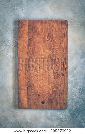 Old Chopping Board On Grey Concrete Background, Copy Space For Your Text