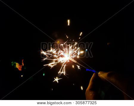 Burning Of Hand Held Sparkle Firework In Black Background