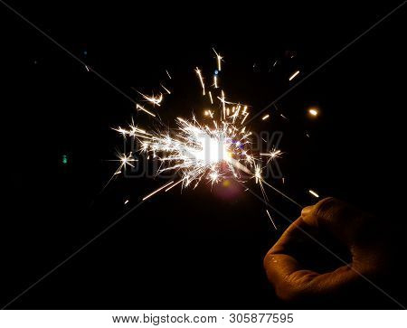 Burning Of Hand Held Sparkle Firework In Black Background