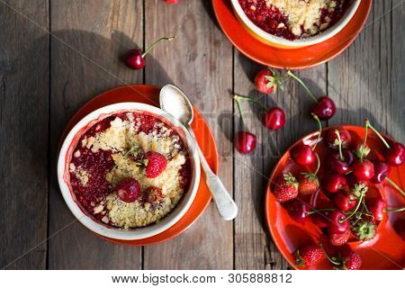 Merry Cherry Crumble With Aromatic Spice On Wooden Rustic Table Top View. Summer Pastry Dessert.