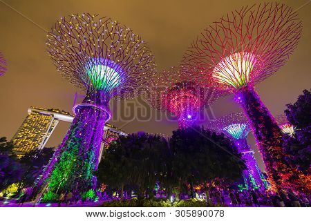 Singapore - April 25 2019 : Singapore Night Skyline At Gardens By The Bay. Supertree Grove Under Blu