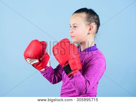 Girl Cute Boxer On Blue Background. Contrary To Stereotype. Boxer Child In Boxing Gloves. Confident 