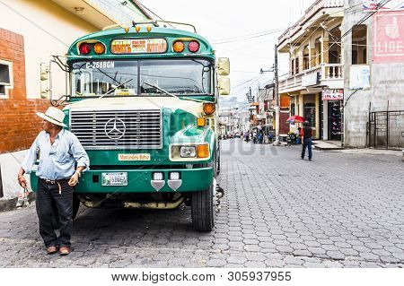 Santiago Atitlan, Lake Atitlan, Guatemala - April 18, 2019: Bus Driver Leans On Refurbished Us Schoo