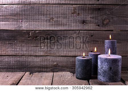 Black  Burning Candles  On Aged Wooden Textured Background. Spa Or Still Life Concept. Selective Foc