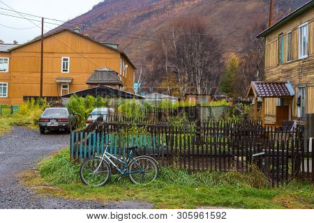 Esso, Kamchatka Peninsula, Russia- 02 October 2014: Wooden Yellow Bulding. Housing Estate In A Small
