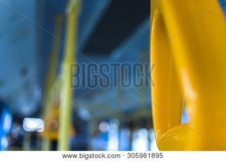 Yellow  Hanging Handhold For Standing Passengers In A Modern Bus. Suburban And Urban Transport