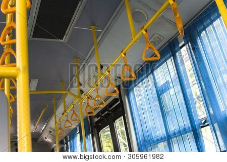Yellow  Hanging Handhold For Standing Passengers In A Modern Bus. Suburban And Urban Transport