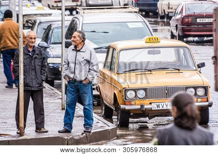 Akhalkalaki, Georgia - May 9, 2017. Taxi And Taxi Driver With Traditional Soviet Car