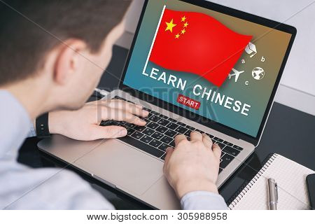 Man Working On Laptop With Learn Chinese On A Screen. Education Learning Chinese Language School Con