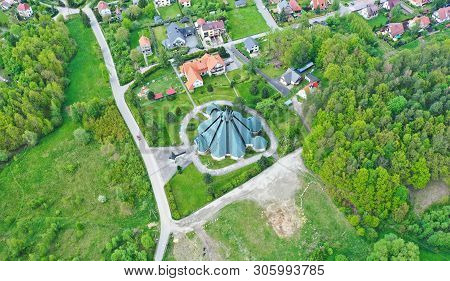 Aerial Perspective View On Touristic City With Catholic Church Surrounded By Meadows And Forest.