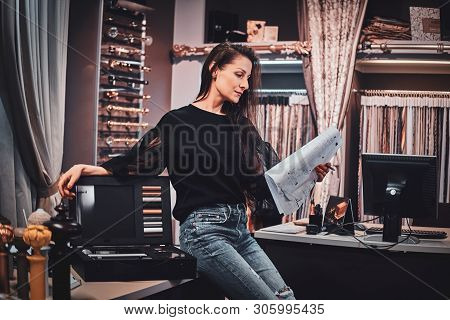 Beautiful Textile Designer Is Sitting On The Table At Her Own Atelier While Thinking About Customers