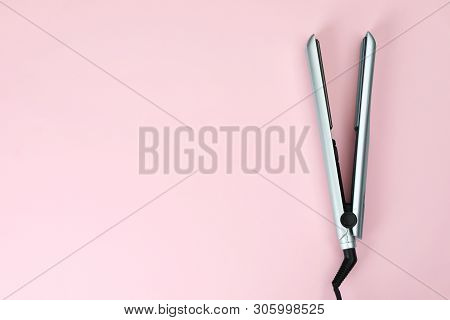 Modern Hair Iron For Straightening On Color Background, Top View With Space For Text