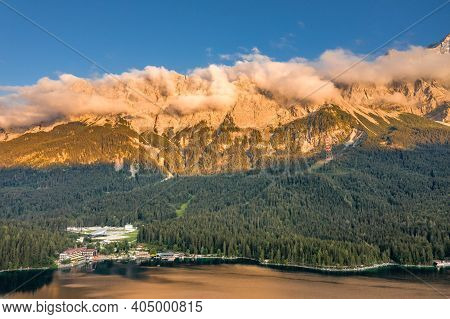 Aerial Drone Shot Of Alpenglow With Fog On Zugspitze By Eibsee Lake In Germany