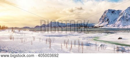 Winter Scenery With Frozen Fjord On Vestvagoy Island At Sunset With Snowy  Mountain Peaks Near Valbe