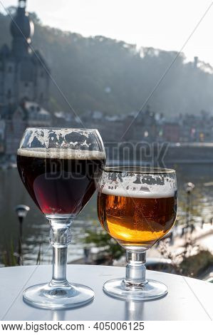 Drinking Of Dark And Strong Belgian Abbey Beer With Cheeses With Nice View On Maas River And Town Di