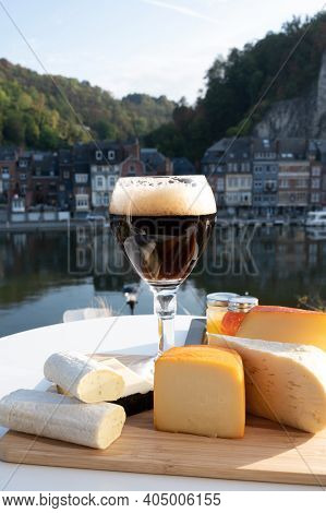 Glass Of Belgian Abbey Beer And Tasting Of Cheeses Made With Trappist Beer And Fine Herbs With View