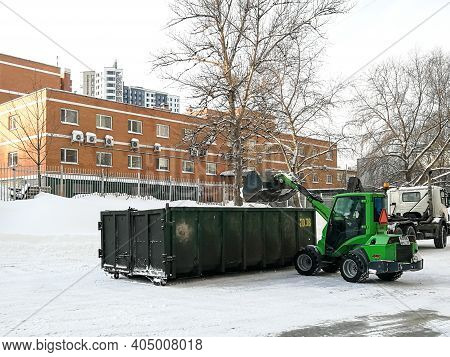 Moscow. Russia. January 15, 2021. Small Front-end Loaders Clear Snow From The Street And Load Into A