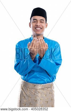 Male Muslim With Head Cap Praying To God