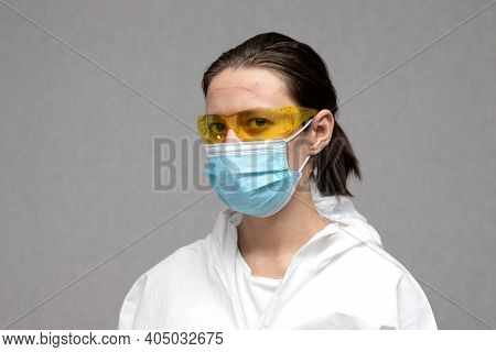 Tired Doctor With Marks On Her Face From A Protective Suite. Coronavirus Covid-19 Outbreak. Overwork