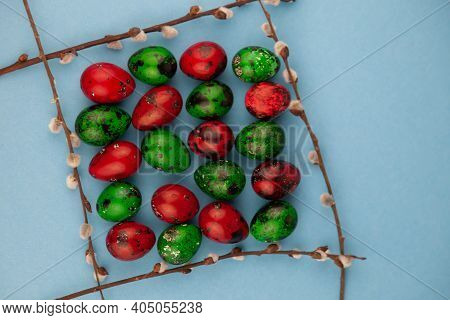 Multicolored Quail Eggs Green And Red On A Blue Background With Place For Text. Happy Easter Postcar