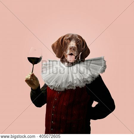 Wine. Model Like Medieval Royalty Person In Vintage Clothing Headed By Dog Head On Pink Pastel Backg