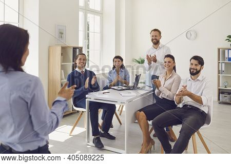 Business People Coworkers Sitting In Office And Applauding Standing Woman Colleague After Successful