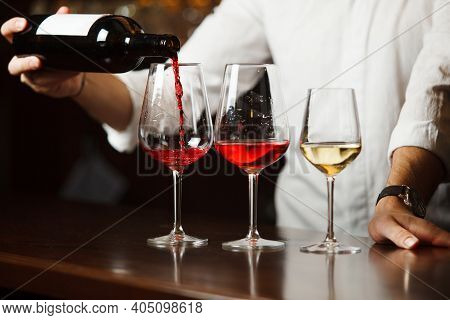 Sommelier Pouring Different Types Of Fine Wine