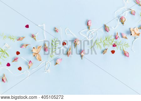 Flowers Composition. Frame Made Of Dried Rose Flowers On Blue Background. Flat Lay, Top View, Copy S