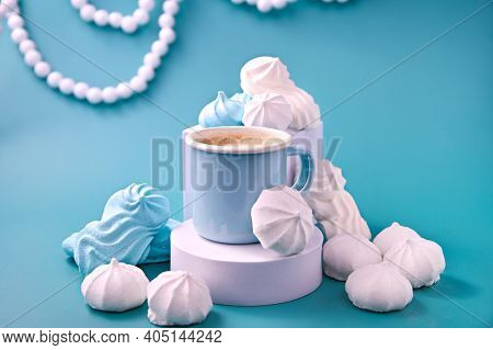 Espresso With Froth And Meringues Of Different Colors On A Blue Background. Meringue. A Creative Sho
