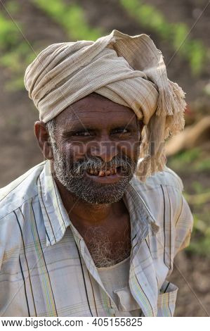 Abbigeri, Karnataka, India - November 6, 2013: Closeup Of Face Of Peanut Farmer. White Turban, Grayi