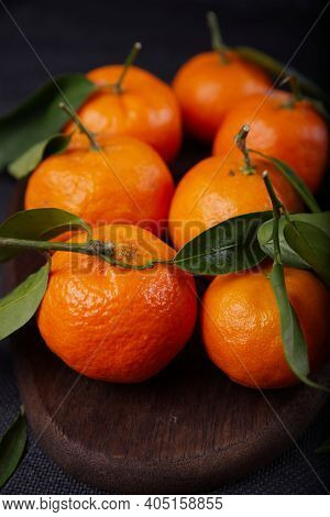 Freshly Harvested Tangerines From Organic Farming Exposed On Dark Background.