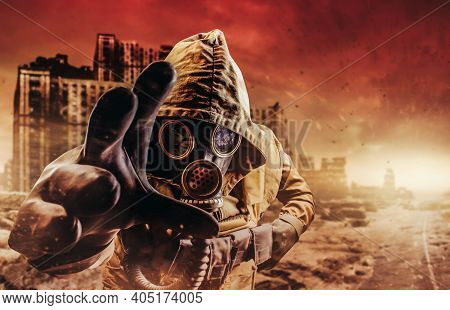 Photo Of A Stalker In Jacket And Gloves In Damaged Gas Mask With Filter Reaching Out His Hand To Cam