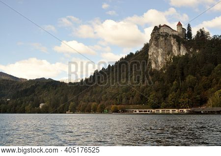 Historic Castle On Hill Above Lake Bled In Slovenia.